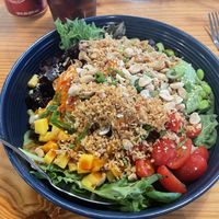Poke bowl with rice, soy beans. Tofu, beets, variety greens, mango, pickled cabbage, tomatoes, crispy garlic, crispy onion, green onion, peanuts, and the house sauce  at Rockin' Ramen in Temple
