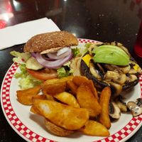 Portobello mushroom burger served with fries at Busy Bee Cafe  in Ventura