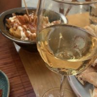 patatas bravas and wine  at Green & Burger in Sant Feliu De Guixols