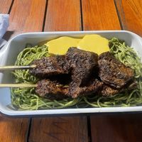 Green noodles with Anticuchos  at Oiga in Lima
