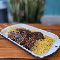 Tallarines en huancaina con anticuchos - 42 soles  at Oiga in Lima