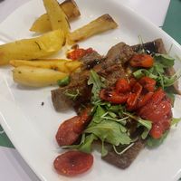 Tagliata di seitan, pomodorini rossi cotti a bassa temperatura, rucola e aceto balsamico (€14)  at La Puntarella Pazza in Rome