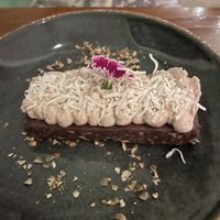 Chocolate no-sugar slice with a tofu cream topping and coconut sprinkles😄 at La Hoja Verde in Tulum