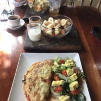 Chickpea and turmeric vegan omelette + fruit bowl with coconut yogurt & agave syrup. at La Hoja Verde in Tulum