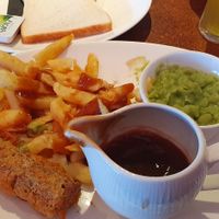 Battered vegan sausage,  chips, mushy peas,  vegan gravy, bread & margarine at The Ocean Fish and Chip Restaurant in Preston