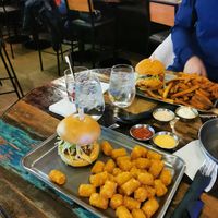 Vegan fried chicken burger and tater tots (front) at Birdhouse in Dollard-des-ormeaux