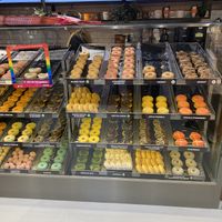 Vegan donuts has a little green sticker on them  at Dunkin' - Copenhagen Central Station in Copenhagen