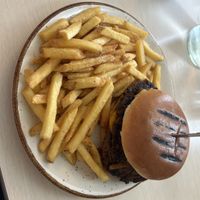 Smash burger- I think it was made with beyond or impossible . It had a cheese sauce that was delicious and the fries were crisp.  at Naustið in Husavik