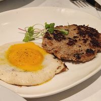 Sides of YoEgg sunny side up and sausage at Vibe Vegan Bistro in Destin