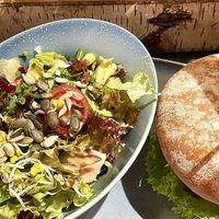 burger with side salad at Hans im Glück - Wien Am Belvedere in Vienna