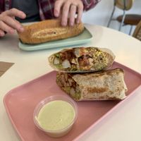 Breakfast burrito with gf tortilla and Philly Sandwhich in the back  at The Moody Vegan in Los Angeles