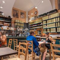 Tea canisters along the walls near the counter at Torteria Olsen in Turin