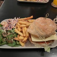 ‘KFM burger’ - fried chick’n style oyster mushroom, with hash brown and salad, served with coleslaw and side salad.  at Orange Cafe Bar in Mousehole