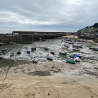 Mousehole is a must see, low tide here fascinating! Town is beautiful and friendly, just short bike ride from Penzance, but buses go here too! at Orange Cafe Bar in Mousehole