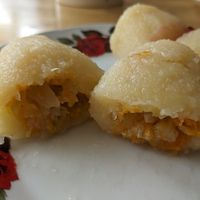 Cepelinai "Sveikuolių“ ("Healthy" Cepelini) - large potato dumplings filled with cabbage, carrot, and onion. (2 pieces) at Bulve (Potato) in Gargzdai