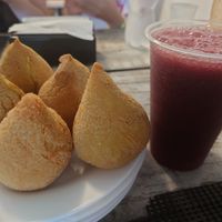 Jackfruit coxinha with fresh pressed mulberry juice at Nova Gokula Iskcon Ashram in Sao Paulo