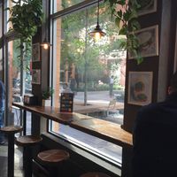 Stools for sitting and eating; plus view of portion of park next door. at Bombay Sandwich Co. in New York City