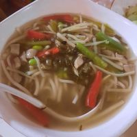 Noodle soup with couple of green beans and red capsicum on top at Gong De Lin in Melbourne