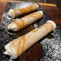 Vegan cannoli “cheesecake” filling with plant based caramel and cherry sauce   at Dharma Bums in New Hope