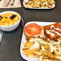 Buffalo tempeh sandwiches with loaded fries and a side of mac ‘n cheese.  at Green Bar and Kitchen in Fort Lauderdale