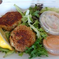 Crabby Cakes. Jackfruit-based cakes with celery seed spices, bed of greens, lemon, slaw, chipotle aioli. Family favorite item of the haul.  at Oh My Cod - Vegan Seafood in Palm Coast