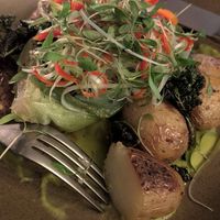 Garlic roast potatoes in pea & lemongrass sauce with bok choi, crispy kale and chilli & spring onion salad at York Minster Refectory in York