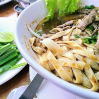 Noodle soup with mushroom 'steak' chunks & selection of fresh herbs at Mercy House in Phnom Penh