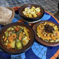 Vegetable tajine, cauliflower tajine half eaten already at this point, chickpea couscous with pumpkin and raisins    at Shyadma's Vegan Food in Essaouira
