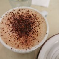 Cappuccino with oatmilk at La Aldea Cafe Bar in Conil De La Frontera