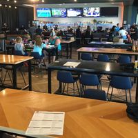 Cafeteria dining area. There is also food and beverage service to each bay. at Topgolf in Brooklyn Center