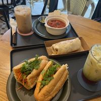 Clockwise from left: Salted Caramel iced latte, tomato soup, chicken wrap, strawberry matcha, banh mi.   at Salon de Vegan in Seoul