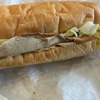 Prime roots cold cut trio sandwich from the case - ready to take to go for a picnic or enjoy in the cafe  at Timeless Coffee Roasters and Bakery in Oakland