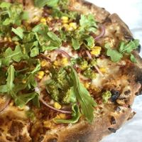 Yummy Gaucho pizza: Vegan Chorizo, Vegan Mozzarella, Toasted Corn, Red Onion, Arugula, Red Sauce, Chimichurri finish 💚  at Saint Paul Brewing in St Paul