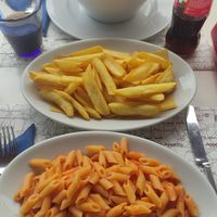 Pasta al pomodoro and french fries at La Rosa Blu in Martinsicuro