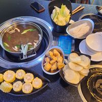 Mushroom broth and vegan ingredients (cabbage, tofu, potatoes, corn, glass noodles, etc.) at Lotus Hot Pot & Grill in Gladstone