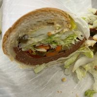 Half of a hot salami sandwich.  Extra napkins, please    at Vegan Deli and Butcher in St Louis