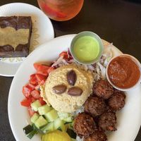 Rice bowl with falafel trio (beet, curry, and traditional), green tahini sauce, spicy harissa sauce, and a tahini swirl brownie!  at Foxy Falafel in St Paul