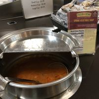 Hot soup bar with clear vegan labeling on the card next to each soup at Fresh Thyme Market in Bloomington