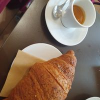 Espresso with a wholegrain croissant filled with jam at Bríccocafè in Livorno