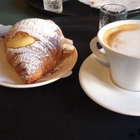 Vegan croissant and cappuccino with soy milk at Sartoria Gastronomica in Bologna