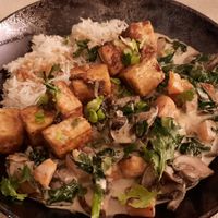Tofu, épinards, champignons bruns, riz, lait coco at Cassis et Romarin in Cassis