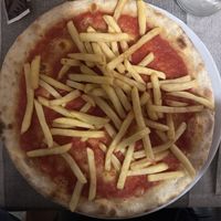 red pizza with french friess  at Il Giardino in Mantova