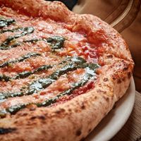 4 fromaggi : tomato sauce, vegan Emmental, paprika cheese, vegan Parmesan, vegan Gorgonzola, and basil pesto at Martha Pizze Amore in Paris