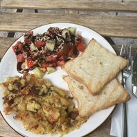 Vegan chickpea omelette with tomato and cucumber salad and bread - very tasty!   at ChikChiki Cafe • ჭიკჭიკი კაფე in Sighnaghi