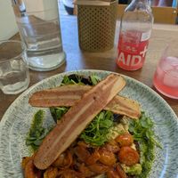 Avocado on sourdough topped with tofu scramble, watercress, tomatoes and bacon. Super filling! at Kollective Kitchen in Sheffield