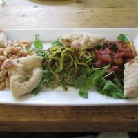 Triple Salad – Warm Caponata, Cannelini bean salad with Walnut sage vinaigrette, romesco courgette ‘Spaghetti’ – served with warm foccacia and rocket leaves at The Green Rocket Cafe in Bath