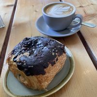 Chocolate and hazelnut croissant with flat oat latte 🌱  at The Green Rocket Cafe in Bath