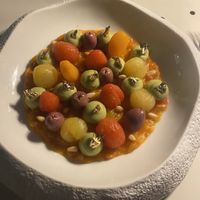 Tomatoes with avocado, olive and gold leaf  at Bulle Restaurant in Lyon