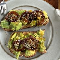 Avocado toast with caramelized  tomatoes   at Papaya Cafe in Santa Maria