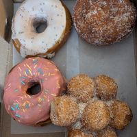 Homer (strawberry with sprinkles), lemon poppyseed, jelly-filled, and donut holes at Doughnut Disturb in Stockholm
